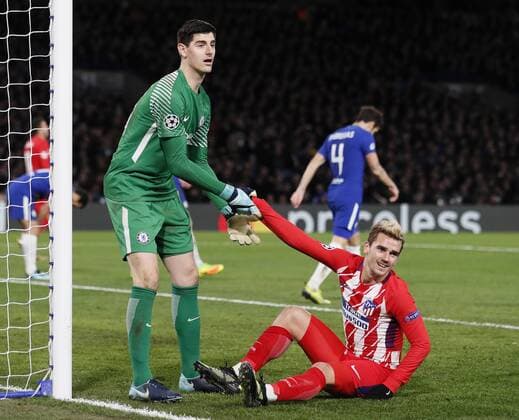 Thibaut Courtois of Chelsea helps up Antoine Griezmann of Atletico Madrid during the Champions League Group C match at the Stamford Bridge, London. Picture date: December 5th 2017. Picture credit should read: David Klein Sportimage EDITORIAL USE ONLY. No use with unauthorised audio, video, data, fixture lists, club league logos or live services. Online in-match use limited to 120 images, no video emulation. No use in betting, games or single club league player publications.