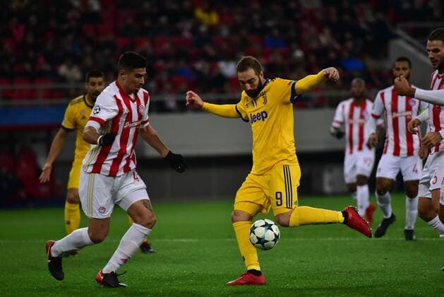 Greece: Champions League Olympiacos vs Juventus Effort of Gonzalo Higuain (no 9) of Juventus to score, in front of Dimitris Nikolaou (no 43) of Olympiacos. Athens Attiki Greece G. Karaiskakis Stadium  DimitriosxKarvountzis PacificxPress