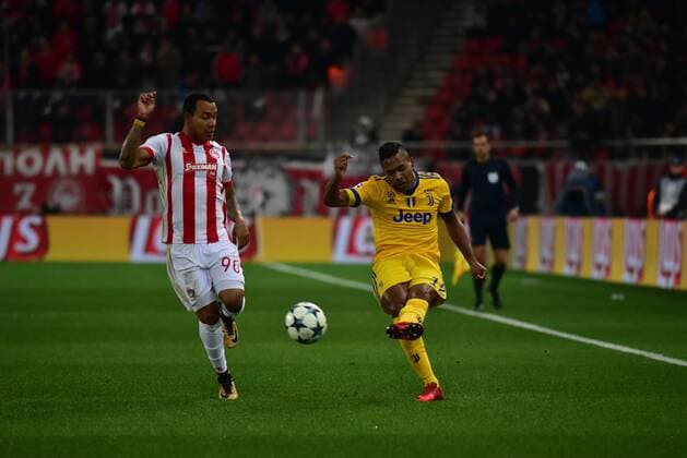 Greece: Champions League Olympiacos vs Juventus Alex Sandro (no 12) of Juventus pass the ball, under the pressure of Felipe Pardo (no 90) of Olympiacos. Athens Attiki Greece G. Karaiskakis Stadium  DimitriosxKarvountzis PacificxPress