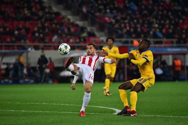 Greece: Champions League Olympiacos vs Juventus Omar Elabdellaoui (no 14) of Olympiacos stops the effort of Medhi Benatia (no 4) of Juventus. Athens Attiki Greece G. Karaiskakis Stadium  DimitriosxKarvountzis PacificxPress