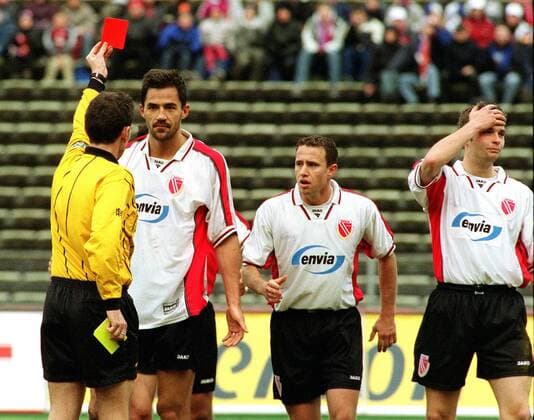 Referee Florian Meyer arrests two Energie Cottbus players from the field because of the applied emergency brake Janos Matyus FC Bayern Energie Cottbus 6 0 on 23 2 2002 in the Munich Olympic Stadium Munich Germany