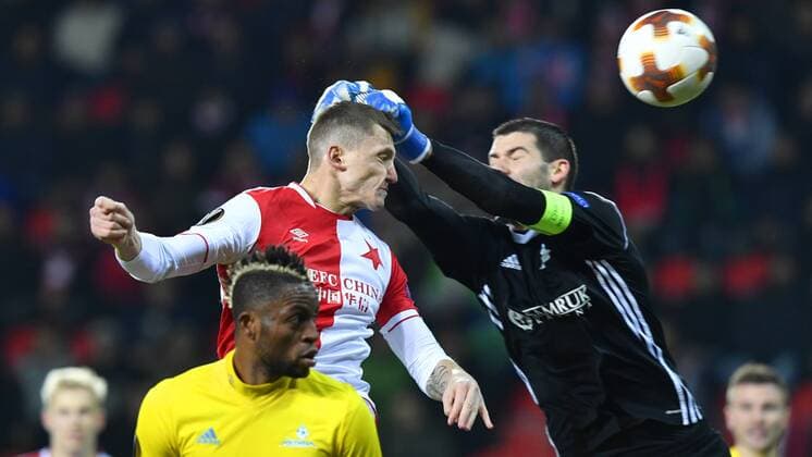 Tomas Necid of Slavia, left, and goalkeeper Nenad Eric of Astana in action during the 6th round, group A, European League soccer match SK Slavia Praha vs FC Astana in Prague, Czech Republic, December 7, 2017. (CTKxPhoto MichalxKamaryt) CTKPhotoP201712071073001  _KMT9339