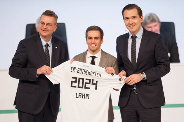 DFB President Reinhard GRINDEL li and Dr Friedrich CURTIUS re DFB secretary-general present the face of the application for the European Championship 2024 to Phillip LAHM DFB Honorary Leader as Ambassador Presentation EM 2024 Extraordinary DFB Bundestag on 08 12 2017 in Frankfurt Germany Â