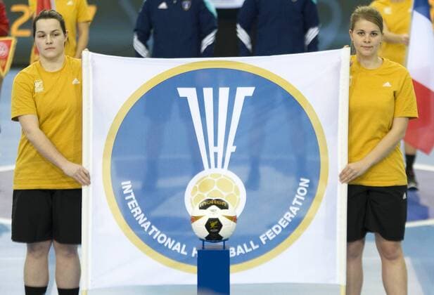 23 Womens Handball World Cup Womens Handball World Cup Quarterfinals in Leipzig France Montenegro 12 12 2017 Two Womens Handball World Cup winners holding a flag of the International Handball Federation IHF is about to watch a quarter ball match ball Game Ball Leipzig Saxony Germany