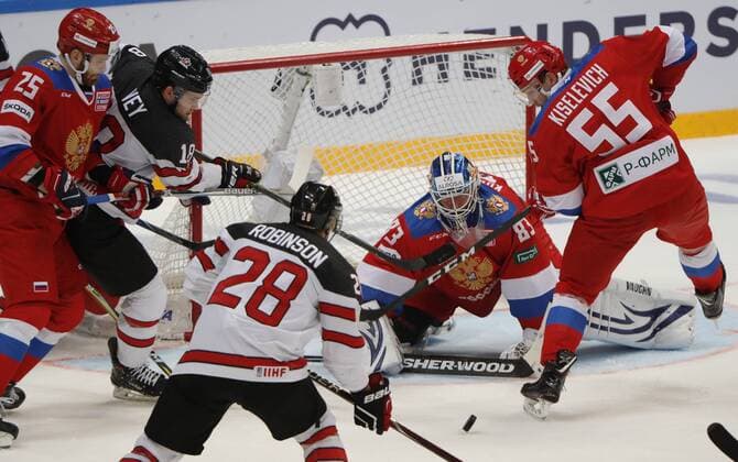 MOSCOW, RUSSIA â€“ DECEMBER 16, 2017: Russiaâ€™s goaltender Vasily Koshechkin (R back) supported by Mikhail Grigorenko (L front) and Bogdan Kiselevich (R front) defends against Canadaâ€™s Mat Robinson (L back) and Linden Vey in their 2017-18 Euro Hockey Tour Channel One Cup Ice hockey Eishockey match at the VTB Ice Palace. Anton Novoderezhkin TASS  TS06D676