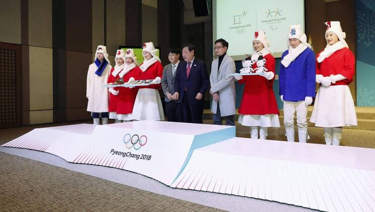 Pyeongchang Olympics Models donning the outfits for assistants who will carry the medals in awards ceremonies of the Pyeongchang Winter Olympics line up near a podium during a preview in Seoul on Dec. 27, 2017. 