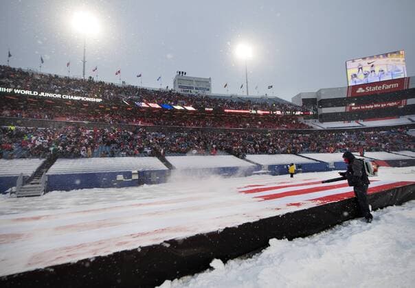 171229 A functionary blaser away snow with a lövblas from an American flag in the period intermission of hockey match between Canada and the United States in the JVM on 29 december 2017 in Buffalo  Copyright: JOELxMARKLUND BB171229JM053