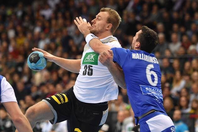 Julius KÜHN GER action battle against Ásgeir HALLGRÍMSSON ISL handball match Germany Iceland on 05 01 2018 P O R S C H E A R E N A Stuttgart