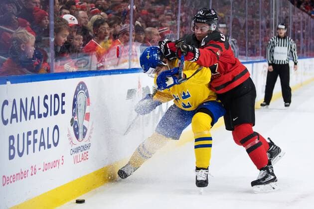 180105 Sweden s Timothy Ladi tackled by Canada s Dillon Dube during ice hockey final between Sweden pa JVM and Canada on 5 January 2018 in Buffalo  Copyright: JOELxMARKLUND BB180105JM031