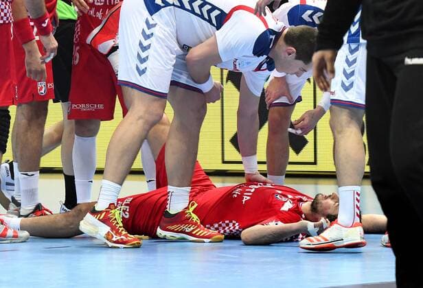 Split Croatia Spaladium arena 12 1 2018 men handball European Championship 2018 Croatia Serbia Mijajlo MARSENIC SEB bends himself over the injured Croatian Domagoj Duvnjak