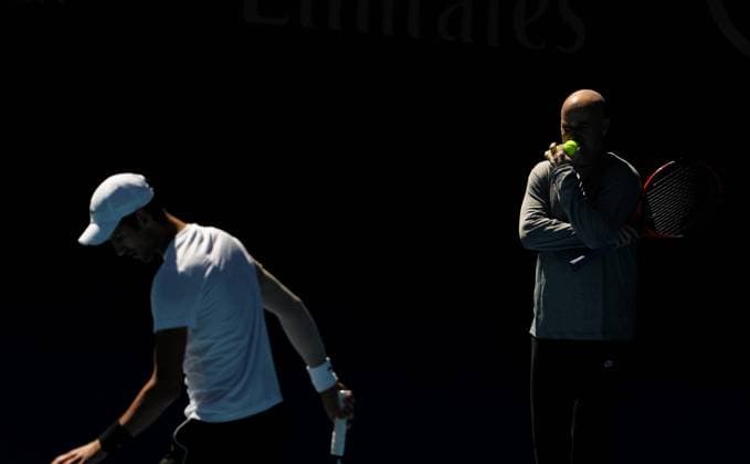 (180114) -- MELBOURNE, Jan. 14, 2018 -- Andre Agassi (R), coach of Serbia s Novak Djokovic, watches during a training session ahead of the Australian Open 2018 at Melbourne Park in Melbourne, Australia, Jan. 14, 2018. ) (SP)AUSTRALIA-MELBOURNE-AUSTRALIAN OPEN-NOVAK DJOKOVIC BaixXuefei 