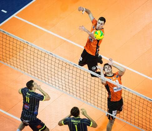 Berlin Germany 17 01 2018 Pierre Pujol BR volleys 18 plays to Graham Vigrass BR volleys 8 against the block from Luka basic Toulouse 11 and Barthélemy Chinenyeze Toulouse 1 playing the CEV volleyball Champions League group A between the Berlin recycling volleys and spacer s Toulouse VB