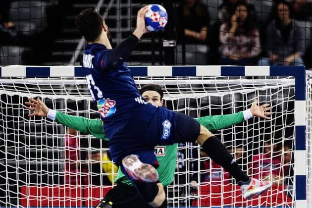 180128 France s Nikola Karabatic jumps and pushes against the Danish malvakt Jannick Green Krejberg in bronze match between Denmark and France in Handball CHAMPIONSHIP 2018 28 January 2018 in Zagreb  Copyright: FREDRIKxVARFJELL BB180128FV041