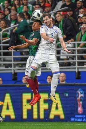 SAN ANTONIO, TX - JANUARY 31: Mexico forward Carlos Vela (11) and Bosnia and Herzegovina midfielder Tomislav Tomic (8) fight for a header during the soccer match between Mexico and Bosnia & Herzegovina on January 31, 2018 at the Alamodome in San Antonio, Texas. (Photo by Ken Murray Icon Sportswire) SOCCER: JAN 31 Mexico v Bosnia & Herzegovina Icon180131035 EDITORIAL USE ONLY