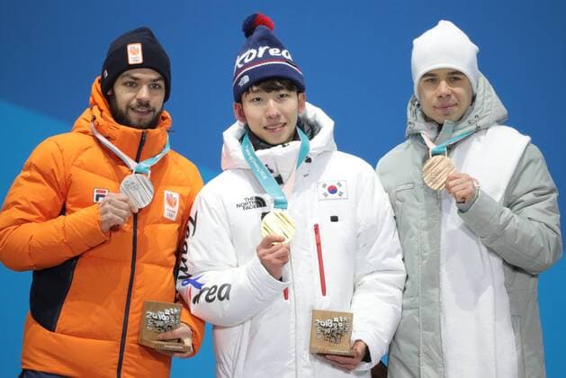 PYEONGCHANG, SOUTH KOREA â€“ FEBRUARY 11, 2018: Silver medallist Sjinkie Knegt of the Netherlands, Gold medallist Lim Hyo-jun of South Korea, and bronze medallist Semyon Yelistratov, Olympic Athlete from Russia, from left, pose at the victory ceremony for the for men s 1500m short track Speed skating Eisschnelllauf event at the 2018 Winter Olympic Games Olympische Spiele Olympia OS at Medals Plaza. Sergei Bobylev TASS  TS0734B0