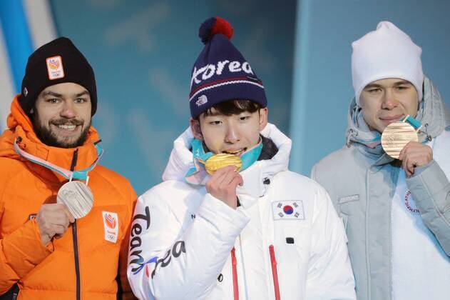 PYEONGCHANG, SOUTH KOREA â€“ FEBRUARY 11, 2018: Silver medallist Sjinkie Knegt of the Netherlands, gold medallist Lim Hyo-jun of South Korea, and bronze medallist Semyon Yelistratov, Olympic Athlete from Russia, from left, pose at the victory ceremony for the for men s 1500m short track Speed skating Eisschnelllauf event at the 2018 Winter Olympic Games Olympische Spiele Olympia OS at Medals Plaza. Sergei Bobylev TASS  TS0734B4