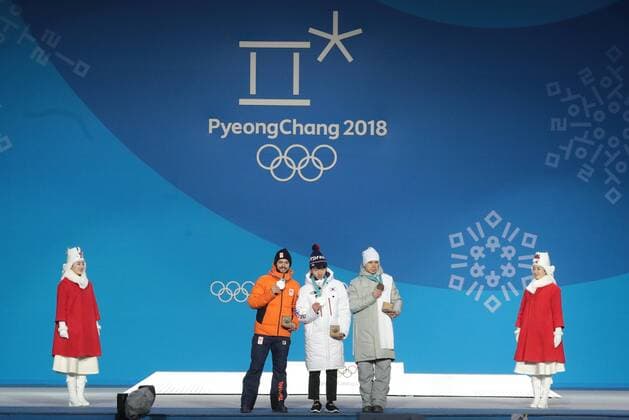 PYEONGCHANG, SOUTH KOREA â€“ FEBRUARY 11, 2018: Silver medallist Sjinkie Knegt of the Netherlands, gold medallist Lim Hyo-jun of South Korea, and bronze medallist Semyon Yelistratov, Olympic Athlete from Russia, from left in the middle, pose at the victory ceremony for the for men s 1500m short track Speed skating Eisschnelllauf event at the 2018 Winter Olympic Games Olympische Spiele Olympia OS at Medals Plaza. Sergei Bobylev TASS  TS0734B8