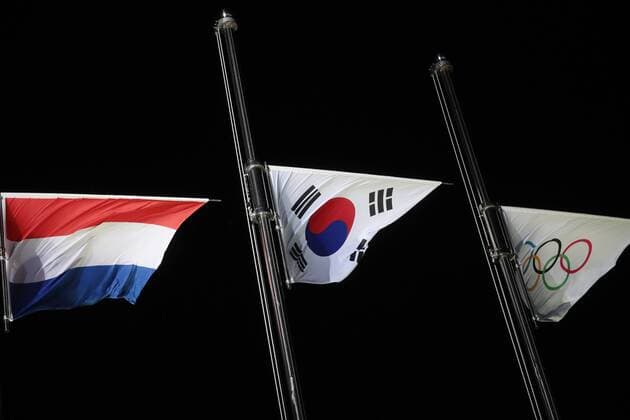 PYEONGCHANG, SOUTH KOREA â€“ FEBRUARY 11, 2018: National flags of the Netherlands, South Korea and the Olympic flag raised at the victory ceremony for the for men s 1500m short track Speed skating Eisschnelllauf event at the 2018 Winter Olympic Games Olympische Spiele Olympia OS at Medals Plaza. Sergei Bobylev TASS  TS0734B9