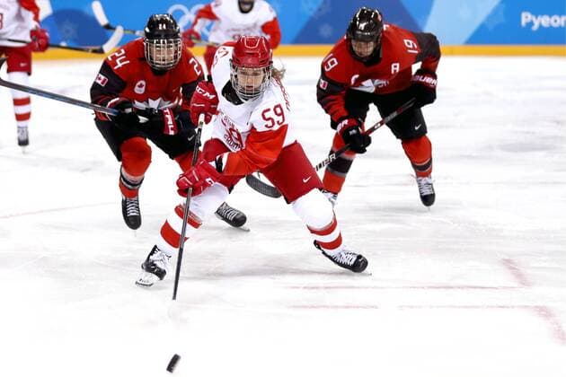 GANGNEUNG, SOUTH KOREA - FEBRUARY 11, 2018: Olympic Athlete from Russia Yelena Dergachyova (C) and Canada s Natalie Spooner (L), Brianne Jenner (R) in action in their women s preliminary round Group A Ice hockey Eishockey match at the 2018 Winter Olympic Games Olympische Spiele Olympia OS at Kwandong Hockey Centre. Valery Sharifulin TASS  TS0734EE