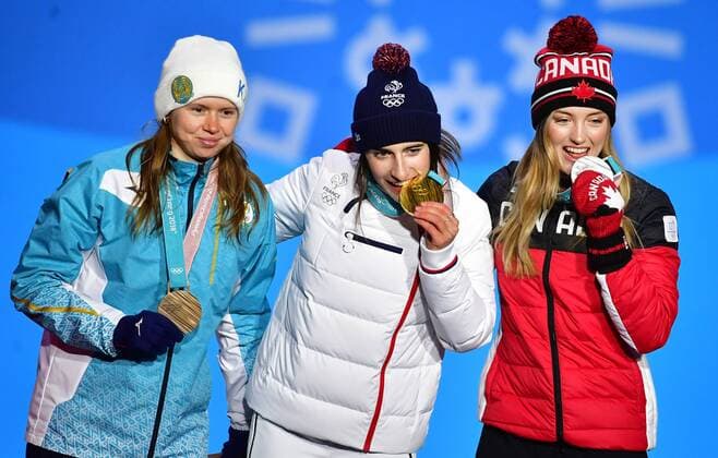 Bronze medalist Kazakstan s Yulia Galysheva (L), gold medalist France s Perrine Laffont (C), and silver medalist Canada s Justine Dufour-Lapointe pose together during the medal ceremony for Ladies Moguls during the Pyeongchang 2018 Winter Olympics in Pyeongchang, South Korea, on February 12, 2018.  OLY20180212345 KEVINxDIETSCH