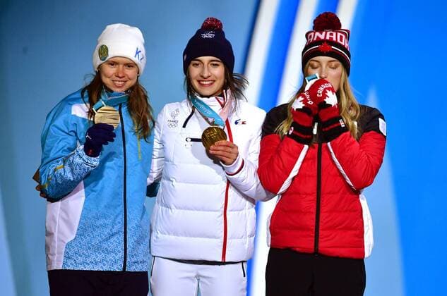 Bronze medalist Kazakstan s Yulia Galysheva (L), gold medalist France s Perrine Laffont (C), and silver medalist Canada s Justine Dufour-Lapointe pose together during the medal ceremony for Ladies Moguls during the Pyeongchang 2018 Winter Olympics in Pyeongchang, South Korea, on February 12, 2018.  OLY20180212356 KEVINxDIETSCH