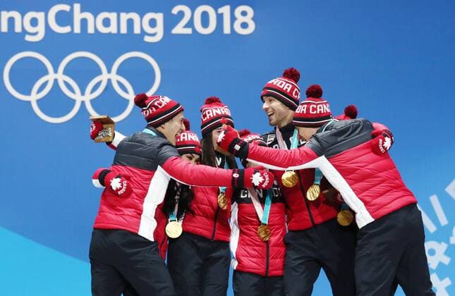 PYEONGCHANG, SOUTH KOREA â€“ FEBRUARY 12, 2018: Figure skaters Patrick Chan, Gabrielle Daleman, Kaetlyn Osmond, Meagan Duhamel, Eric Radford, Tessa Virtue, and Scott Moir of Canada pose with their gold medals at the victory ceremony for the Figure skating Eiskunstlauf team event at the 2018 Winter Olympic Games Olympische Spiele Olympia OS Valery Sharifulin TASS  TS0737C4