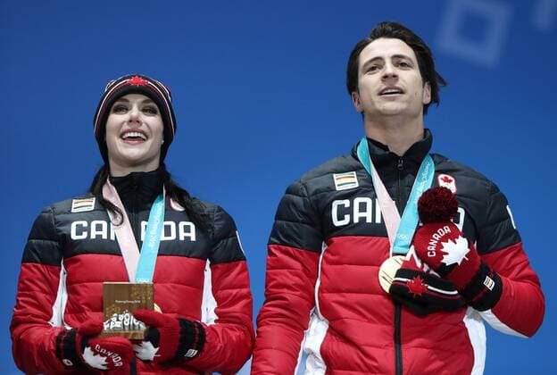 PYEONGCHANG, SOUTH KOREA â€“ FEBRUARY 12, 2018: Ice dancers Tessa Virtue and Scott Moir of Canada pose with their gold medals at the victory ceremony for the Figure skating Eiskunstlauf team event at the 2018 Winter Olympic Games Olympische Spiele Olympia OS Valery Sharifulin TASS  TS0737C8