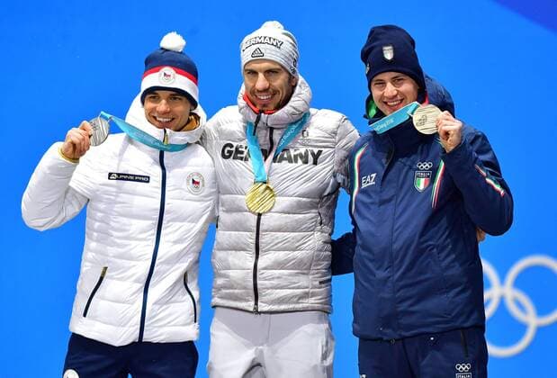 Silver medalist Czech Republic s Michal Krcmar (L), gold medalist Arnd Peiffer (C) and bronze medalist Italy s Dominik Windisch pose during the medal ceremony for Biathlon Men s 10km Sprint at the medal s plaza during the Pyeongchang 2018 Winter Olympics in Pyeongchang, South Korea, on February 13, 2018.  OLY20180213380 KEVINxDIETSCH