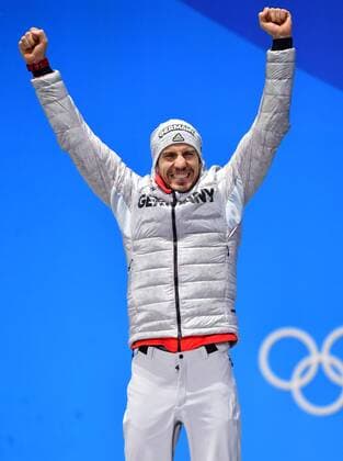 Gold medalist Germany s Arnd Peiffer celebrates during the medal ceremony for Biathlon Men s 10km Sprint at the medal s plaza during the Pyeongchang 2018 Winter Olympics in Pyeongchang, South Korea, on February 13, 2018.  OLY20180213381 KEVINxDIETSCH