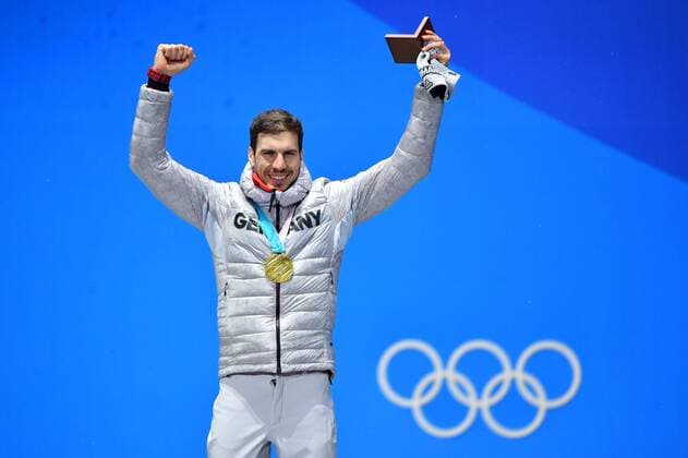Gold medalist Germany s Arnd Peiffer celebrates during the medal ceremony for Biathlon Men s 10km Sprint at the medal s plaza during the Pyeongchang 2018 Winter Olympics in Pyeongchang, South Korea, on February 13, 2018.  OLY20180213382 KEVINxDIETSCH
