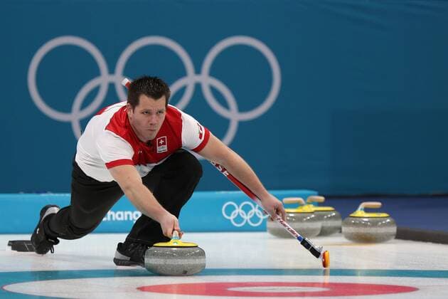 Martin Rios of Switzerland delivers a stone during the Gold Medal Mixed Doubles game against Canada at the Gangneung Curling Center in Gangneung, South Korea during the 2018 Pyeongchang Winter Olympics on February 13, 2018. Canada won 10-3.  OLY20180213820 ANDREWxWONG