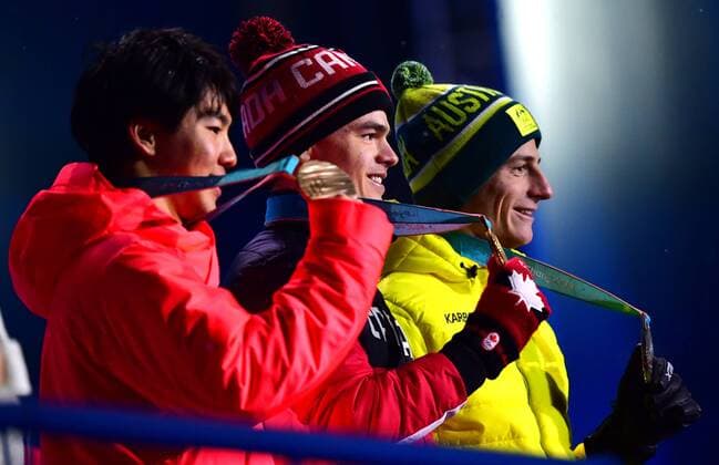 Bronze medalist Japan s Daichi Hara (L), gold medalist Canada s Mikael Kingsburh (C) and Silver medalist Australia s Matt Graham pose together during the medal ceremony for Men s Moguls at the medal s plaza during the Pyeongchang 2018 Winter Olympics in Pyeongchang, South Korea, on February 13, 2018.  OLY20180213355 KEVINxDIETSCH