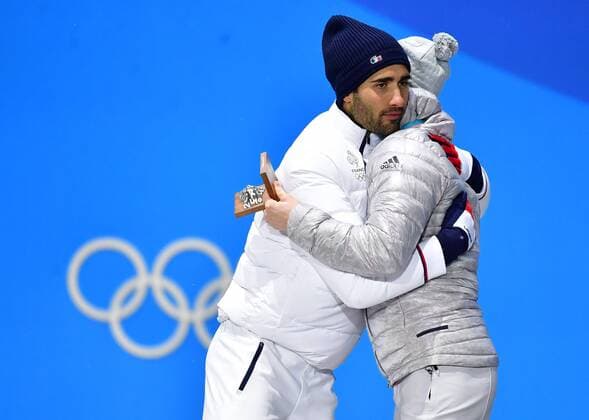 Gold medalist France s Martin Fourcade (L) hugs bronze medalist Germany s Benedikt Doll during the medal ceremony for Biathlon Men s 12.5km Pursuit at the medal s plaza during the Pyeongchang 2018 Winter Olympics in Pyeongchang, South Korea, on February 13, 2018.  OLY20180213369 KEVINxDIETSCH