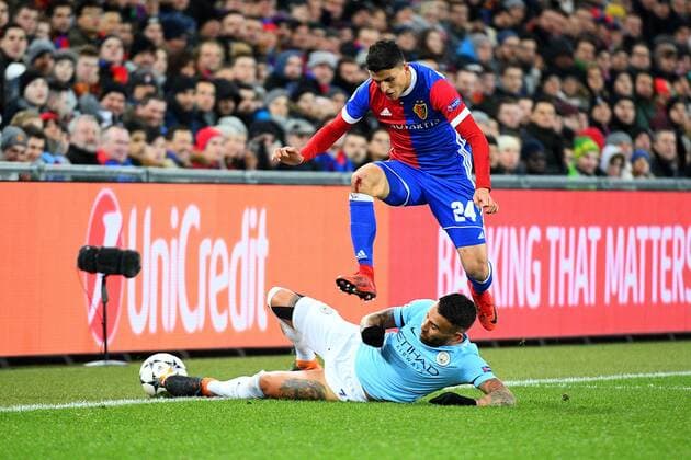 13th February 2018, St Jakob Park, Basel, Switzerland; UEFA Champions League football, round of 16, first leg, FC Basel versus Manchester City; Nicolas Otamendi of Manchester City challenges Mohamed Elyounoussi of FC Basel for the ball  ActionPlus11986668