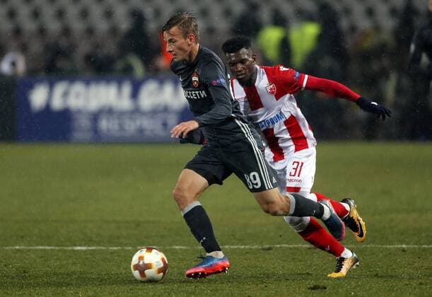 (180214) -- BELGRADE, Feb. 14, 2018 -- CSKA Moscow s Konstantin Kuchaev (L) vies with Crvena Zvezda s El Fardou Ben Nabouhane during the UEFA Europa League round of 32 first leg football match between Crvena Zvezda and CSKA Moscow in Belgrade, Serbia on Feb. 13, 2018. The match ended with 0-0.) (SP)SERBIA-BELGRADE- EUROPA-FOOTBALL-CRVENA ZVEZDA VS CSKA PredragxMilosavljevic 