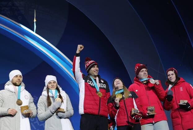 PYEONGCHANG, SOUTH KOREA - FEBRUARY 14, 2018: Bronze medalists, Olympic Athletes from Russia Anastasia Bryzgalova and Aleksandr Krushelnitckii, Gold medalists, Canada s Kaitlyn Lawes and John Morris and Silver medalists, Switzerland s Jenny Perret and Martin Rios (L-R) during a medal ceremony for the curling mixed doubles competition at the 2018 Winter Olympic Games Olympische Spiele Olympia OS at Medals Plaza. Sergei Bobylev TASS  TS073C0E