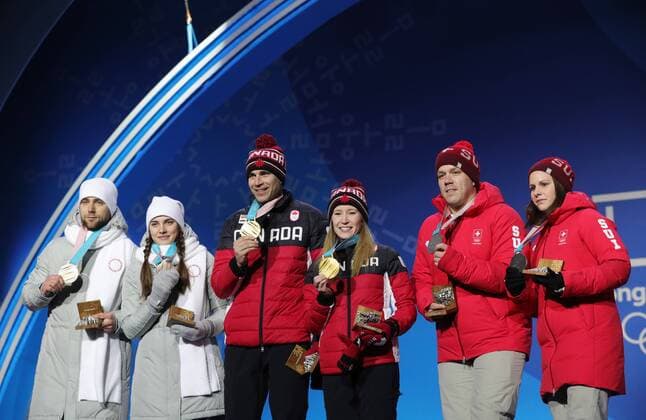 PYEONGCHANG, SOUTH KOREA - FEBRUARY 14, 2018: Bronze medalists, Olympic Athletes from Russia Anastasia Bryzgalova and Aleksandr Krushelnitckii, Gold medalists, Canada s Kaitlyn Lawes and John Morris and Silver medalists, Switzerland s Jenny Perret and Martin Rios (L-R) during a medal ceremony for the curling mixed doubles competition at the 2018 Winter Olympic Games Olympische Spiele Olympia OS at Medals Plaza. Sergei Bobylev TASS  TS073C0F