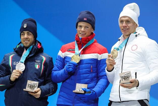 Silver medalist, Italy s Federico Pellegrino, Gold medalist, Norway s Johannes Hoesflot Klaebo and Bronze medalist, Olympic Athlete from Russia Alexander Bolshunov (L-R) at a medal ceremony for the men s cross-country skiing individual sprint classic event at the 2018 Winter Olympic Games Olympische Spiele Olympia OS at Medals Plaza. Sergei Bobylev TASS  TS073C17
