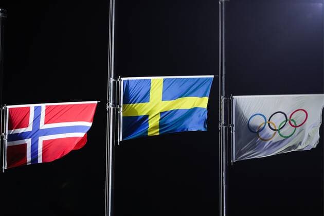 PYEONGCHANG, SOUTH KOREA - FEBRUARY 14, 2018: The Norwegian national flag, the Swedish national flag and the Olympic flag (L-R) during a medal ceremony for the ladies cross-country skiing individual sprint classic event at the 2018 Winter Olympic Games Olympische Spiele Olympia OS at Medals Plaza. Sergei Bobylev TASS  TS073C44