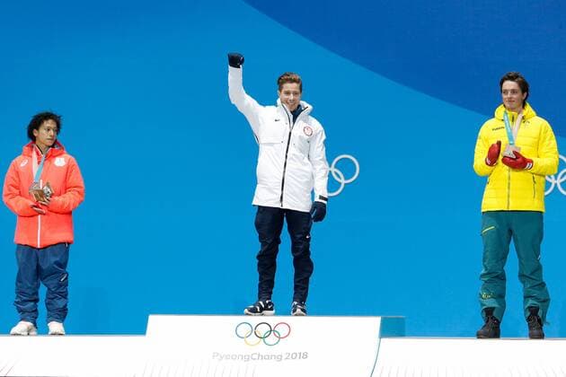 MenÕs Snowboard Halfpipe gold medalist Shaun White of the United States celebrates at the medals ceremony for the 2018 Pyeongchang Winter Olympics at the Pyeongchang Medals Plaza in Pyeongchang, South Korea, on February 14, 2018. At left is silver medalist Ayumu Hirano of Japan and bronze medalist Scotty James of Australia at right.  OLY20180214141 MATTHEWxHEALEY