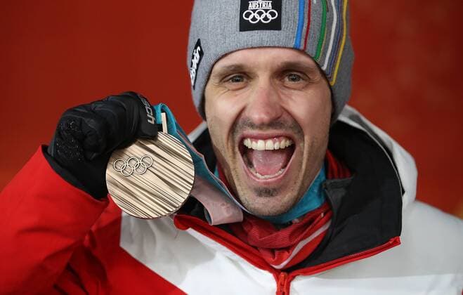 OLYMPICS - 2018 Winter Olympics PYEONGCHANG,SOUTH KOREA,15.FEB.18 - OLYMPICS,NORDIC SKIING, NORDIC COMBINED - Olympic Winter games Winterspiele Spiele Summer games PyeongChang 2018, Medals Plaza, award ceremony. Image shows Lukas Klapfer (AUT). Keywords: medal. GEPAxpictures xAndreasxPranter