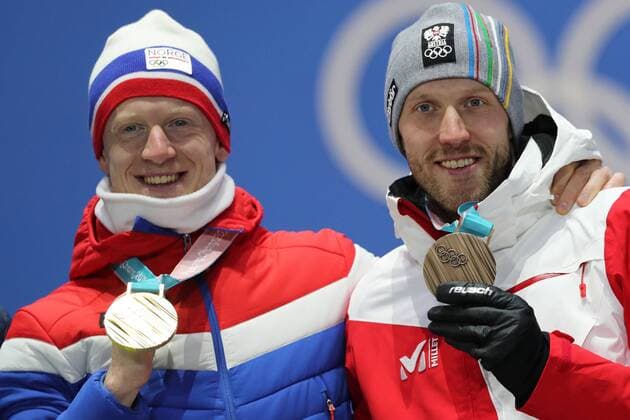 OLYMPICS - 2018 Winter Olympics PYEONGCHANG,SOUTH KOREA,16.FEB.18 - OLYMPICS, BIATHLON - Olympic Winter games Winterspiele Spiele Summer games PyeongChang 2018, Medals Plaza, 20km biathlon, men, award ceremony. Image shows Johannes Thingnes Boe (NOR) and Dominik Landertinger (AUT). keywords: medal. GEPAxpictures xMathiasxMandl