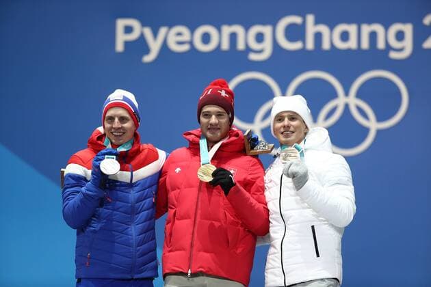 PYEONGCHANG, SOUTH KOREA â€“ FEBRUARY 16, 2018: Bronze medallist Denis Spitsov, Olympic Athlete from Russia, gold medallist Dario Cologna of Switzerland, and silver medallist Simen Hegstad Krueger of Norway, from right, pose at a victory ceremony for the men s 15km freestyle cross-country skiing race at the 2018 Winter Olympic Games Olympische Spiele Olympia OS Valery Sharifulin TASS  TS074314