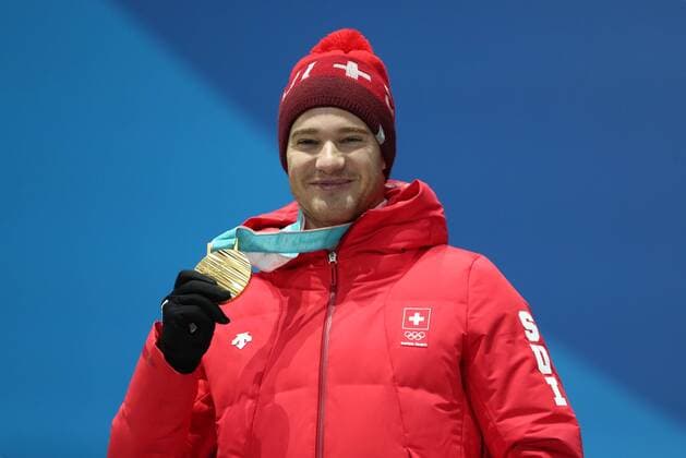 PYEONGCHANG, SOUTH KOREA â€“ FEBRUARY 16, 2018: Skier Dario Cologna of Switzerland poses with his gold medal at a victory ceremony for the men s 15km freestyle cross-country skiing race at the 2018 Winter Olympic Games Olympische Spiele Olympia OS Valery Sharifulin TASS  TS074319