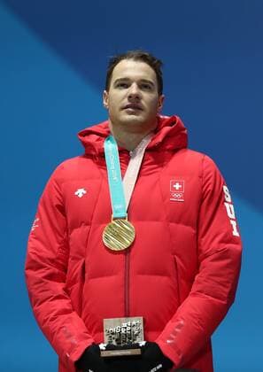 PYEONGCHANG, SOUTH KOREA â€“ FEBRUARY 16, 2018: Skier Dario Cologna of Switzerland poses with his gold medal at a victory ceremony for the men s 15km freestyle cross-country skiing race at the 2018 Winter Olympic Games Olympische Spiele Olympia OS Valery Sharifulin TASS  TS07431E