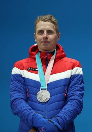 PYEONGCHANG, SOUTH KOREA â€“ FEBRUARY 16, 2018: Skier Simen Hegstad Krueger of Norway poses with his silver medal at a victory ceremony for the men s 15km freestyle cross-country skiing race at the 2018 Winter Olympic Games Olympische Spiele Olympia OS Valery Sharifulin TASS  TS07431F