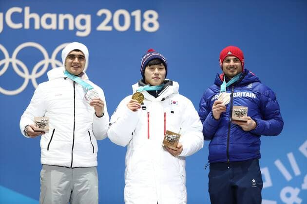 PYEONGCHANG, SOUTH KOREA - FEBRUARY 16, 2018: Silver medalist, Olympic Athlete from Russia Nikita Tregubov, Gold medalit, South Korea s Sungbin Yun and Bronze medalist, Great Britain s Dominic Dom Parsons (L-R) celebrate during a victory ceremony for the men s skeleton event at the 2018 Winter Olympic Games Olympische Spiele Olympia OS at Medal Plaza. Valery Sharifulin TASS  TS074323