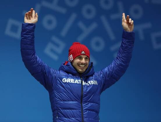 PYEONGCHANG, SOUTH KOREA - FEBRUARY 16, 2018: Bronze medalist, Great Britain s Dominic Dom Parsons celebrates during a victory ceremony for the men s skeleton event at the 2018 Winter Olympic Games Olympische Spiele Olympia OS at Medal Plaza. Valery Sharifulin TASS  TS074333