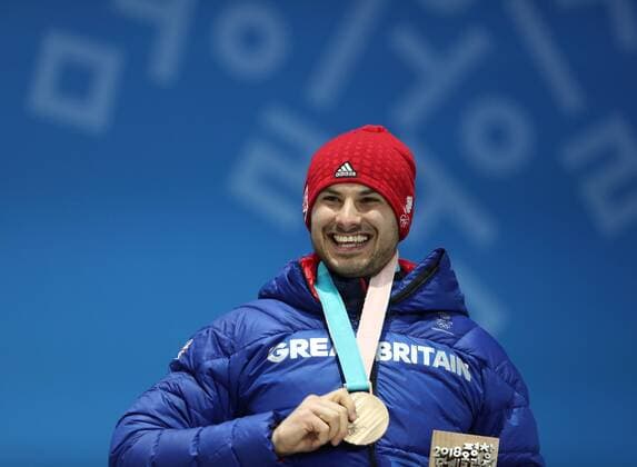 PYEONGCHANG, SOUTH KOREA - FEBRUARY 16, 2018: Bronze medalist, Great Britain s Dominic Dom Parsons celebrates during a victory ceremony for the men s skeleton event at the 2018 Winter Olympic Games Olympische Spiele Olympia OS at Medal Plaza. Valery Sharifulin TASS  TS074334