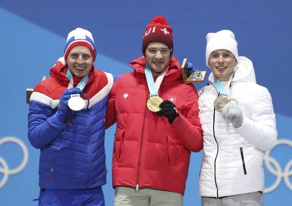 (180216) -- PYEONGCHANG, Feb. 16, 2018 -- Champion Dario Cologna (C) of Switzerland, second-placed Simen Hegstad Krueger (L) of Norway and third-placed Olympic athlete from Russia Denis Spitsov pose for photos during medal ceremony of men s 15km free event of cross country skiing at 2018 PyeongChang Winter Olympic Games Olympische Spiele Olympia OS at Medal Plaza, PyeongChang, South Korea, Feb. 16, 2018. ) (SP)OLY-SOUTH KOREA-PYEONGCHANG-CROSS COUNTRY SKIING-MEN S 15KM FREE-MEDAL CEREMONY BaixXuefei 